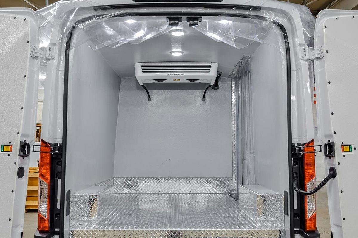 refrigerated van interior,onboard digital temperature monitor, properly packed food inventory.